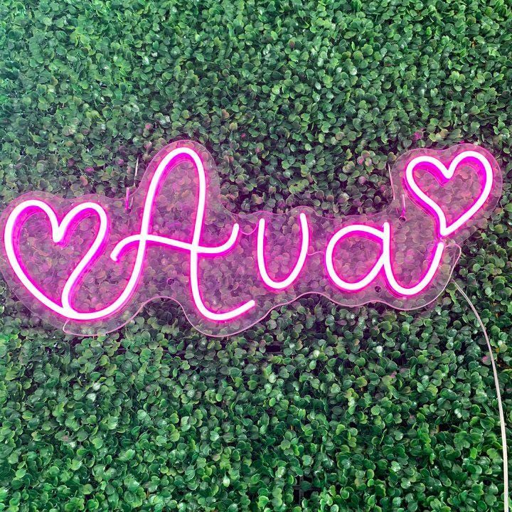 "Ava" name LED Neon sign By LedNeons.com - glowing softly on a wall, adding a personalized and stylish touch to the decor.