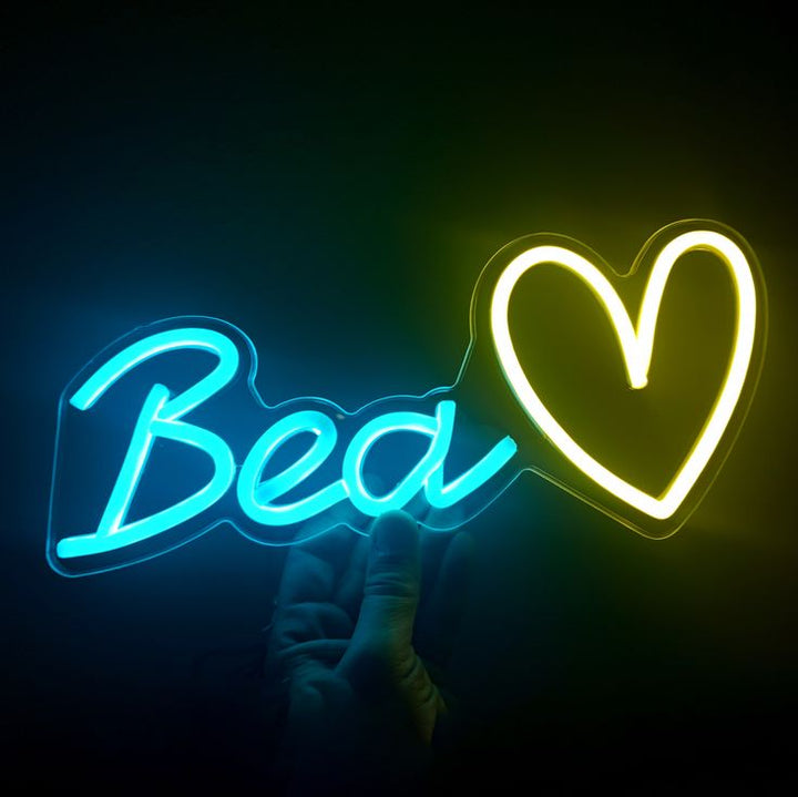 "Bea" name LED Neon sign by LEDNeons  -  glowing on a wall, offering a custom and charming decorative accent.
