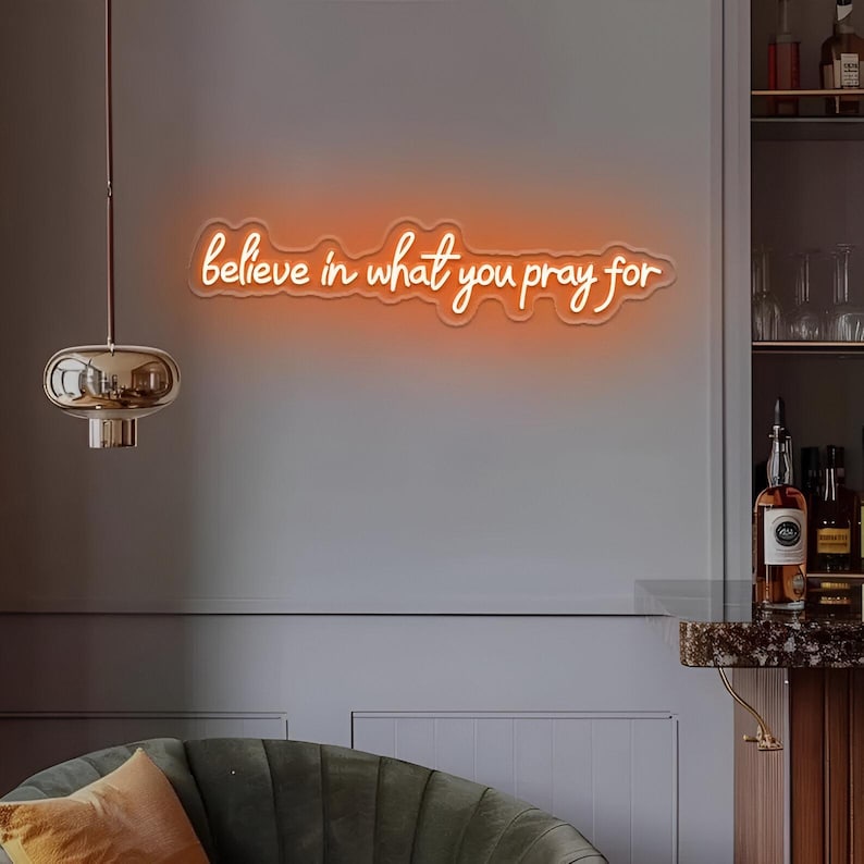 Believe in What You Pray For" LED Neon sign by LedNeons.com - glowing gently on a wall, adding a faith-inspired touch to a peaceful home setting.