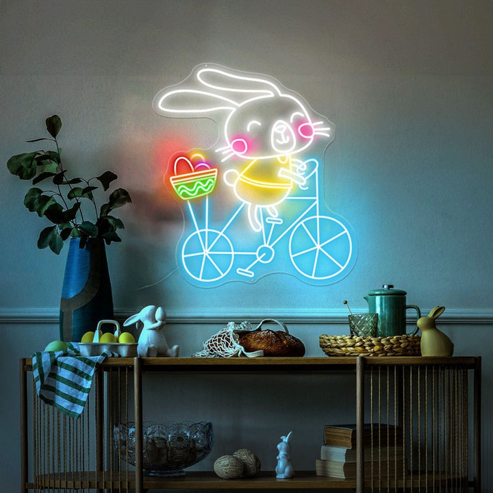 Bunny on Bike Easter neon sign glowing on wall by LEDNeons