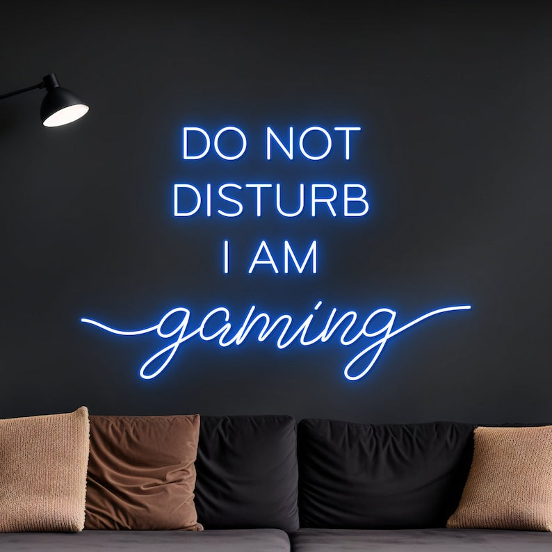 "Do Not Disturb I Am Gaming" LED Neon sign by LEDNeons -  lit up on a wall, adding bold style to a gamer’s room.