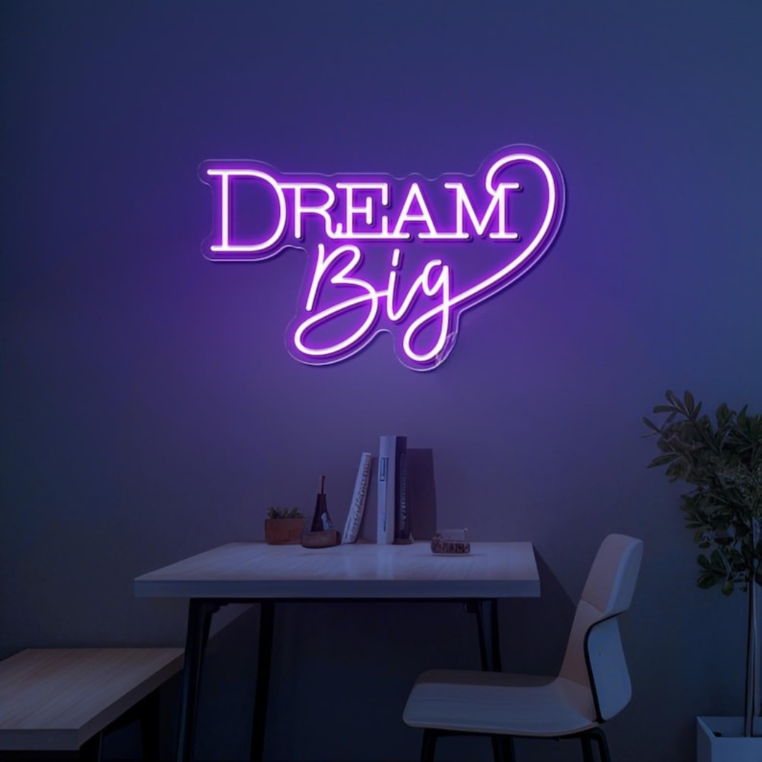 Dream Big LED neon sign by LEDNeons  -  glowing on a wall, creating a warm and motivational atmosphere in a cozy room or workspace.