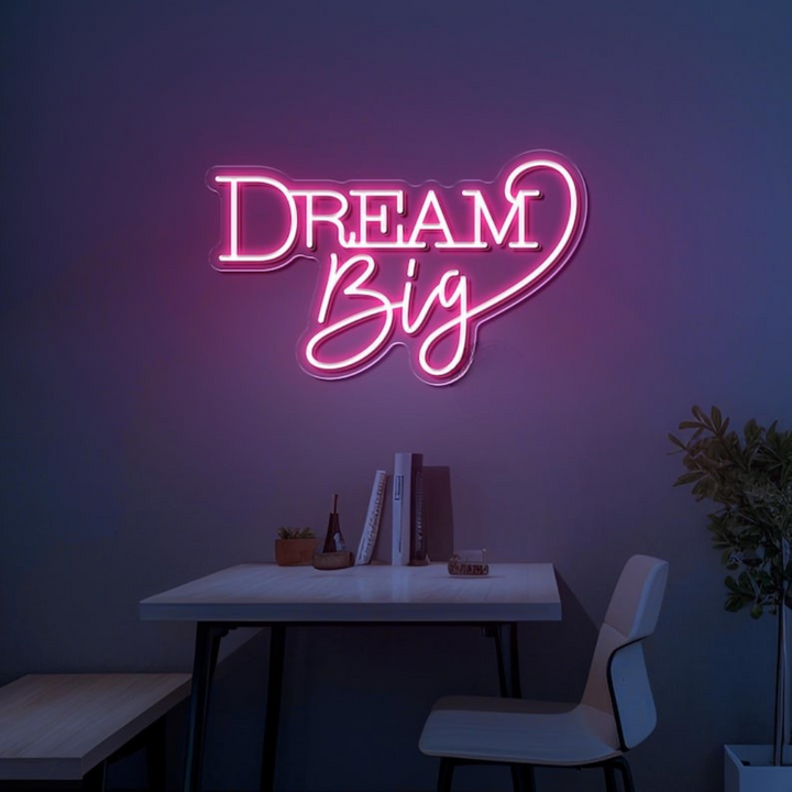Dream Big LED neon sign by LEDNeons  -  glowing on a wall, creating a warm and motivational atmosphere in a cozy room or workspace.