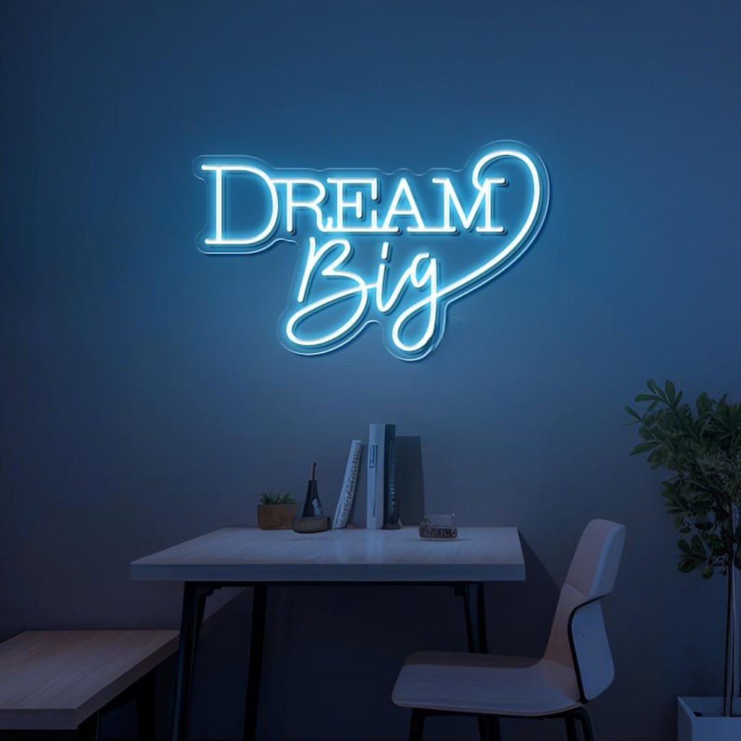 Dream Big LED neon sign by LEDNeons  -  glowing on a wall, creating a warm and motivational atmosphere in a cozy room or workspace.