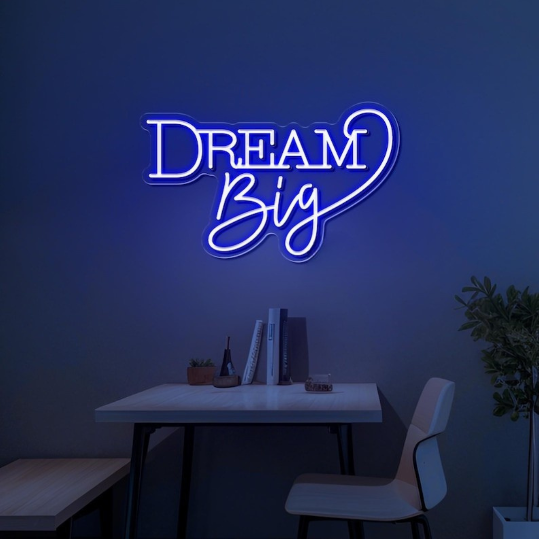 Dream Big LED neon sign by LEDNeons  -  glowing on a wall, creating a warm and motivational atmosphere in a cozy room or workspace.