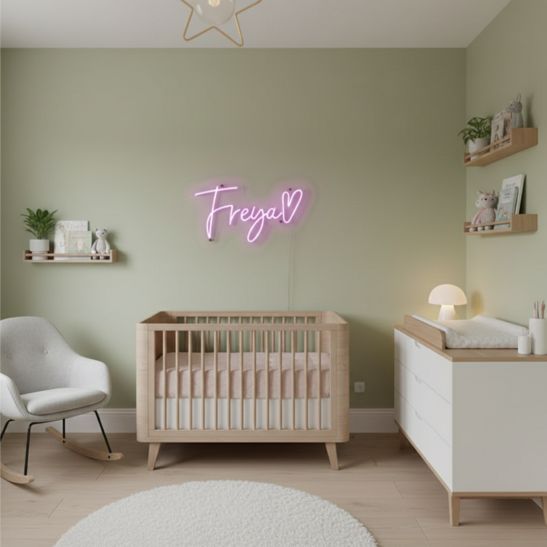 Freya Name LED Neon Sign by LEDNeons -  glowing in stylish cursive font on a wall backdrop