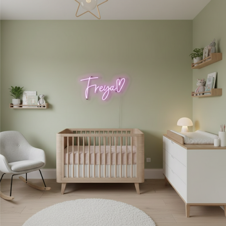 Freya Name LED Neon Sign by LEDNeons -  glowing in stylish cursive font on a wall backdrop