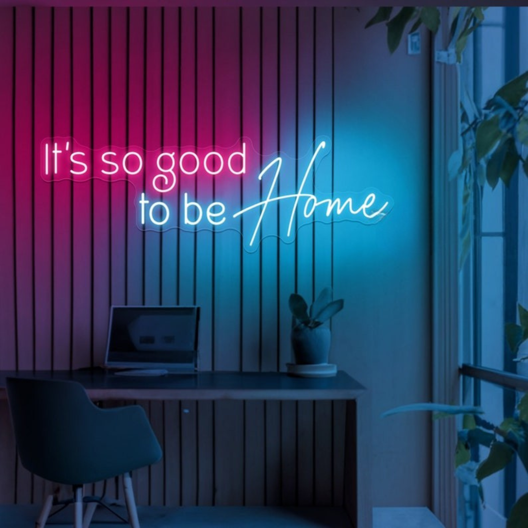 It's So Good To Be Home Neon Sign by LEDNeons  - Glowing in warm light, mounted on a wall in a cozy home setting.
