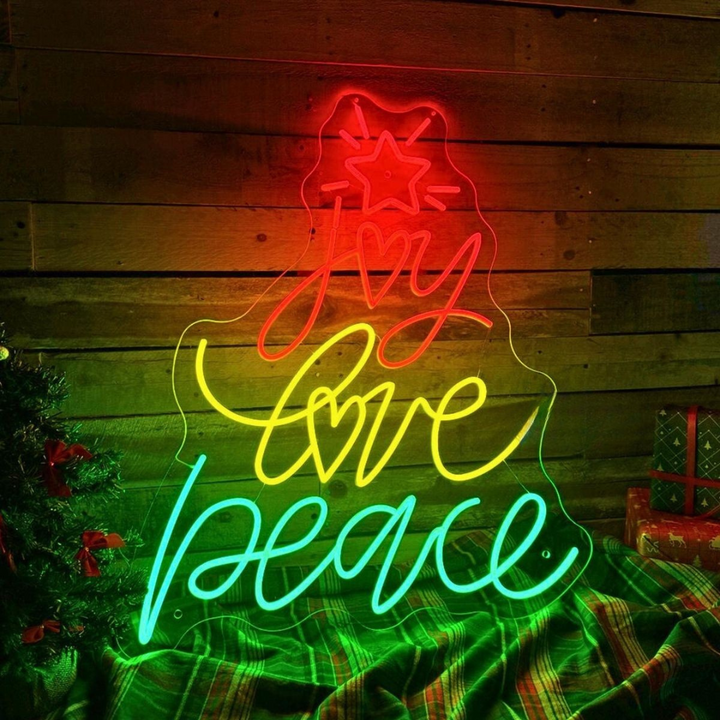Joy Love Peace Merry Christmas Neon Sign by LEDNeons - glowing in vibrant neon colors for a cheerful atmosphere.