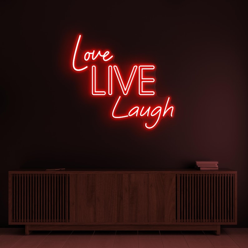 Love Live Laugh LED Neon Sign by LEDNeons  -  with glowing script text, ideal for adding a positive and uplifting vibe to home or office decor.