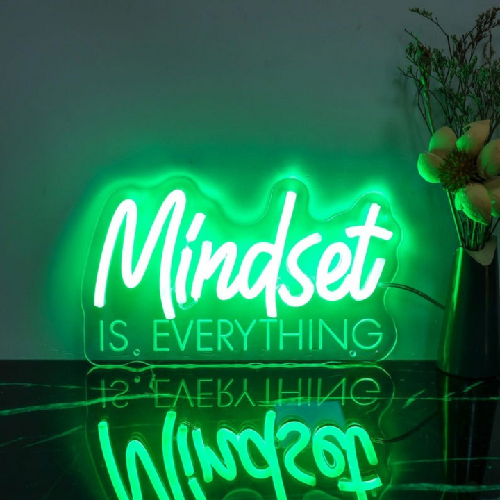 Mindset is Everything" LED Neon sign by LEDNeons - Glowing brightly on a wall, creating a motivational atmosphere in a home office or personal workout space.