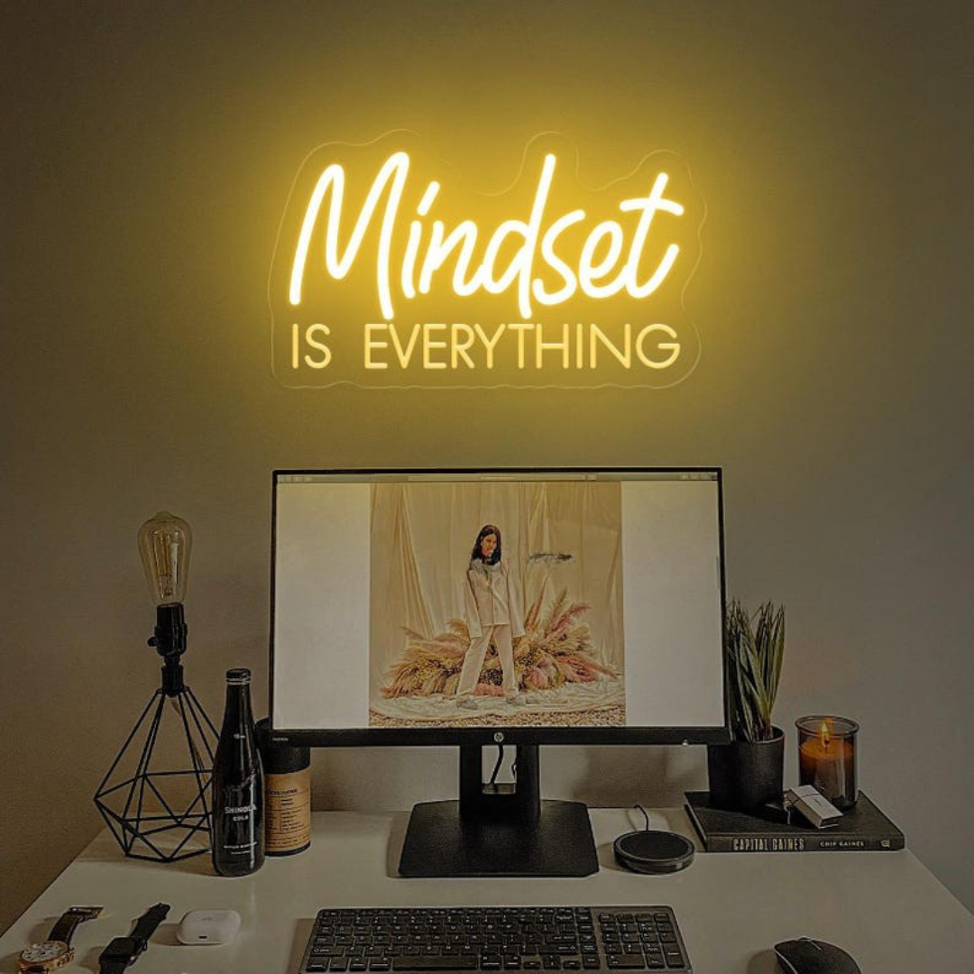 Mindset is Everything" LED Neon sign by LEDNeons - Glowing brightly on a wall, creating a motivational atmosphere in a home office or personal workout space.