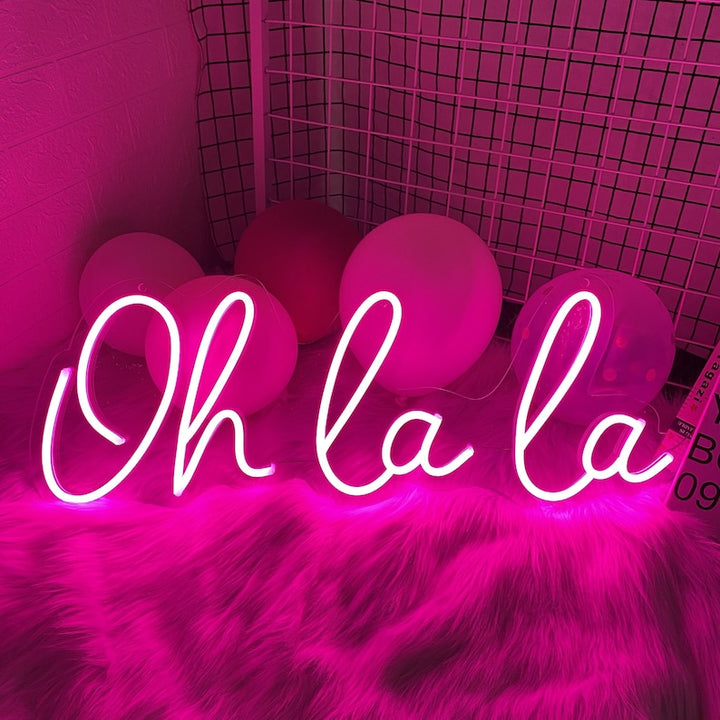 Oh La La! LED Neon Sign by LedNeons.com- with glowing cursive neon lettering, perfect for adding a chic and playful touch to bedrooms, or party spaces