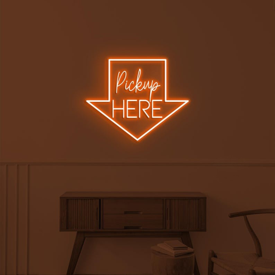 Pick Up Here" With Arrow Neon sign by LEDNeons - brightly glowing to direct customers to the pickup area.
