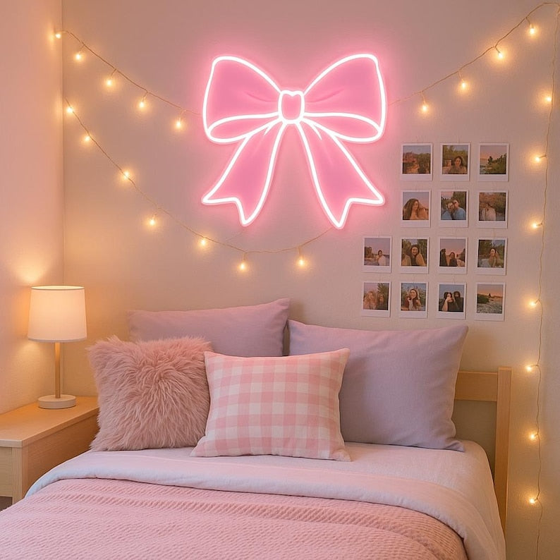 Pink bow-shaped LED Neon sign by LedNeons.com - glowing softly on a wall, adding a cute and feminine touch to the decor.