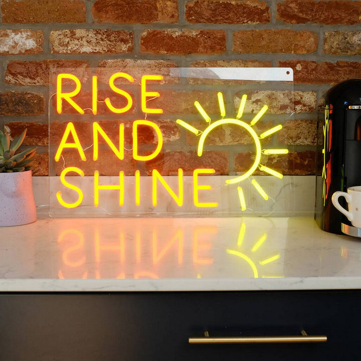 Rise and Shine" LED Neon sign by LEDNeons  - glowing brightly on a wall, adding a cheerful and uplifting vibe to the room.