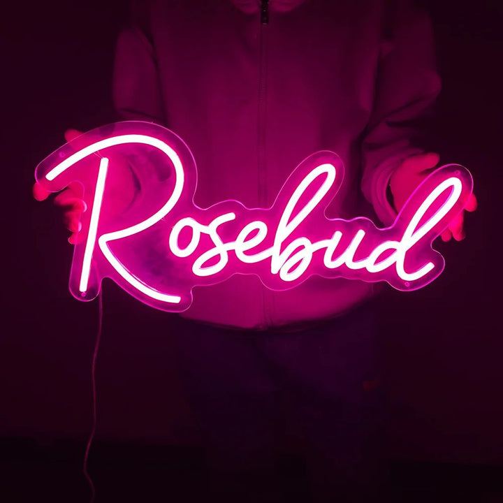 Rosebud Name LED Neon sign by LedNeons.com - glowing softly on a wall, adding a whimsical and personalized decorative touch.










