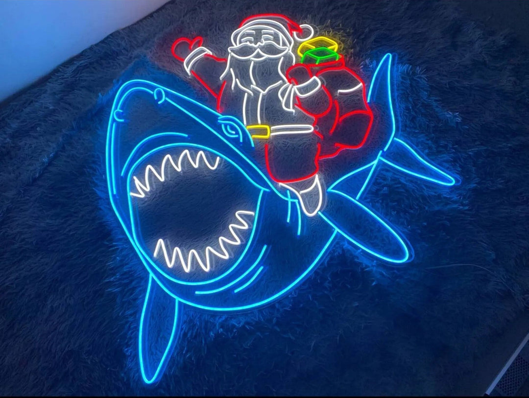 Santa Claus on Shark Merry Christmas Neon Sign by LEDNeon's - Add a fun and quirky touch to your holiday décor with this Santa on shark neon sign.