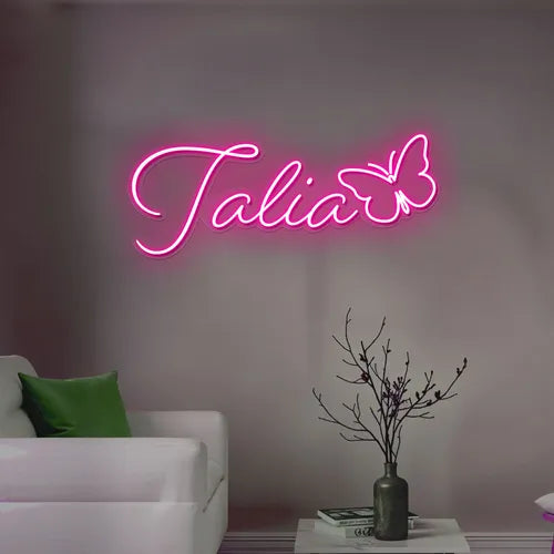 Talia Name LED Neon Sign by LEDNeons - glowing in elegant cursive font on wall backdrop"