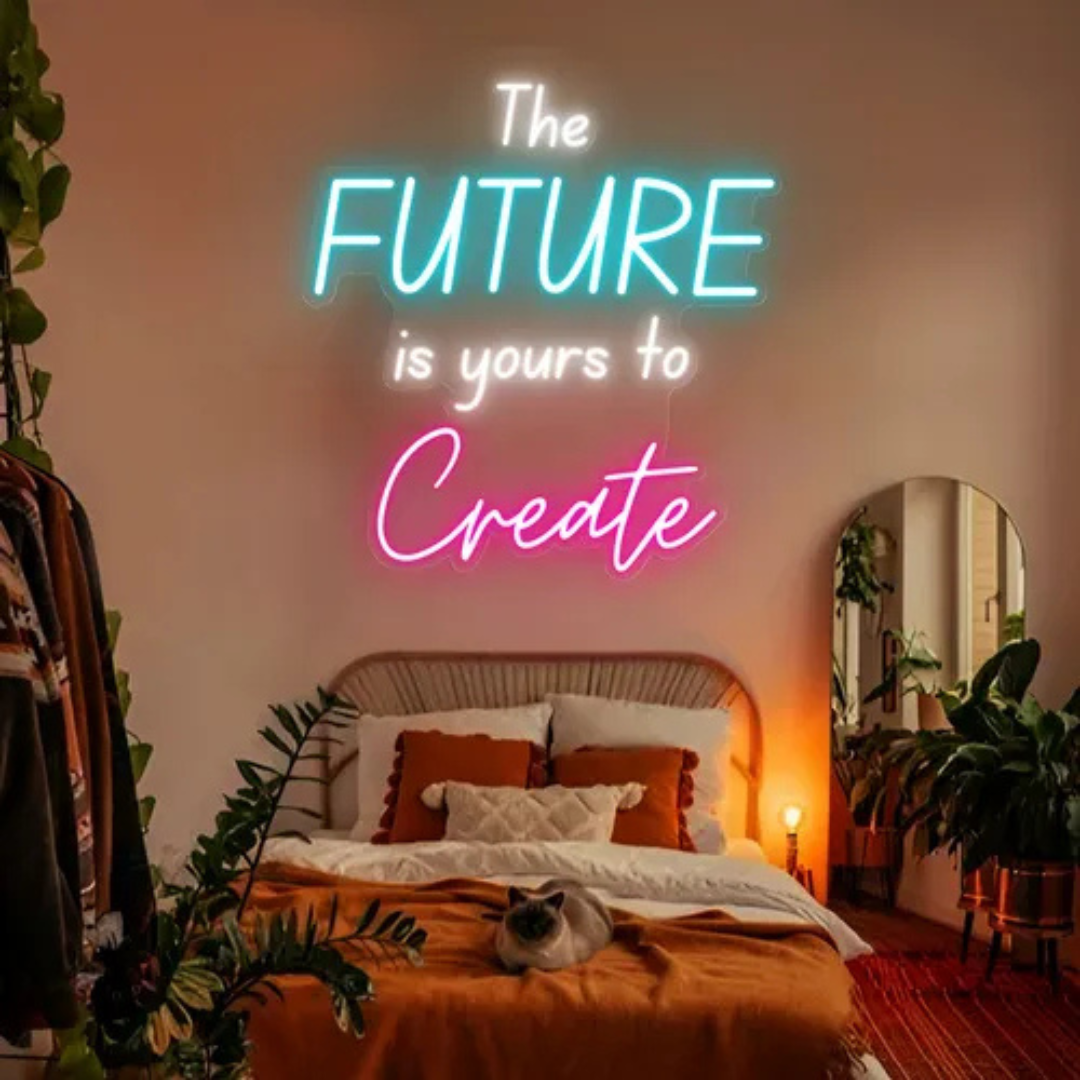 "The Future is Yours to Create" LED neon sign by LEDNeons -  glowing in stylish script, mounted on a wall in a modern home office or creative space, radiating motivational energy.