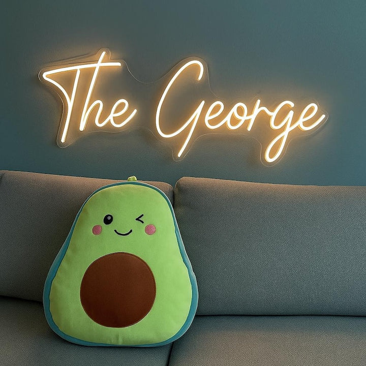 "The George Name LED Neon Sign by LEDNeons - glowing in modern cursive font on wall backdrop"