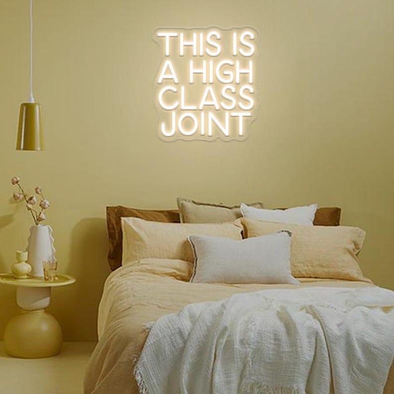 This Is A High Classy Joint LED Neon Sign by LedNeons.com -  with bold, vintage-style neon lettering, ideal for adding a playful and stylish touch to bars or home decor.