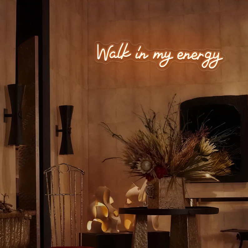 Walk In My Energy" LED Neon sign  by LEDNeons - glowing boldly on a wall, adding a confident and empowering vibe to the space.
