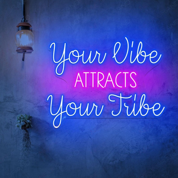 Your Vibe Attracts Your Tribe LED Neon sign by LedNeons.com  glowing brightly on a wall, creating a positive and welcoming atmosphere.