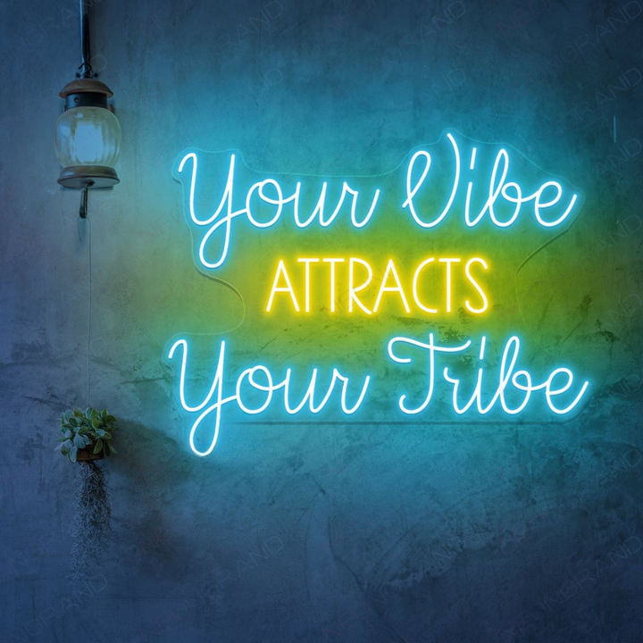 Your Vibe Attracts Your Tribe" LED Neon sign by LEDNeons  glowing brightly on a wall, creating a positive and welcoming atmosphere.